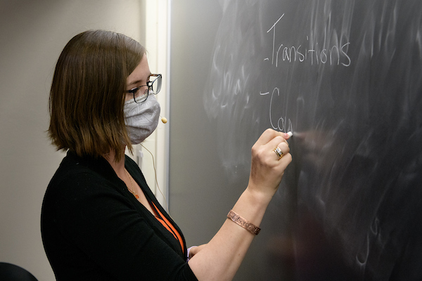 Instructor writing on whiteboard